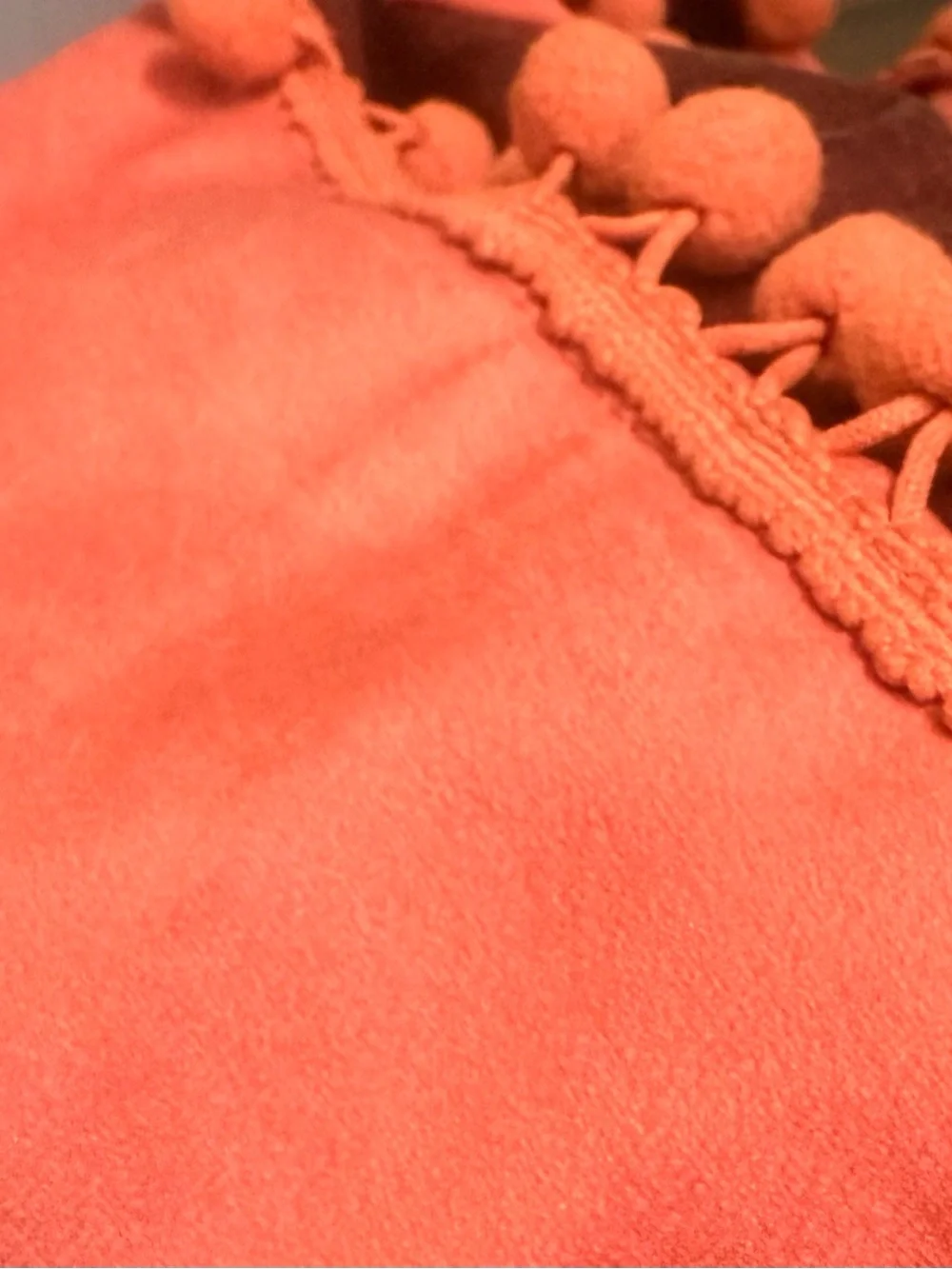 Burnt orange curtain panels with pompoms